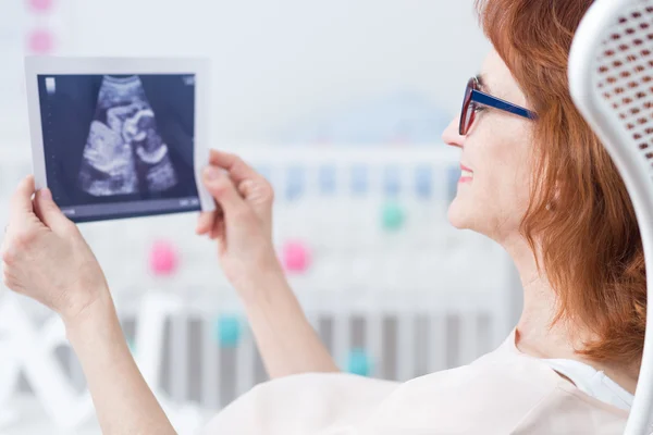 Looking at first baby's photo — Stock Photo, Image