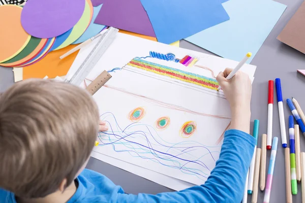 Creative boy and colorful boat — Stock Photo, Image