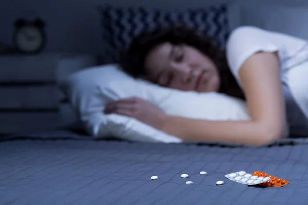Sleeping pills on bed