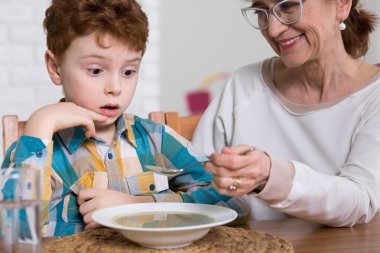 Zavallı yiyen çocuk öğle yemeği sırasında