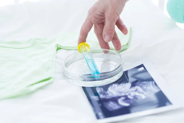 Pregnancy ultrasound and test tube — Stock Photo, Image