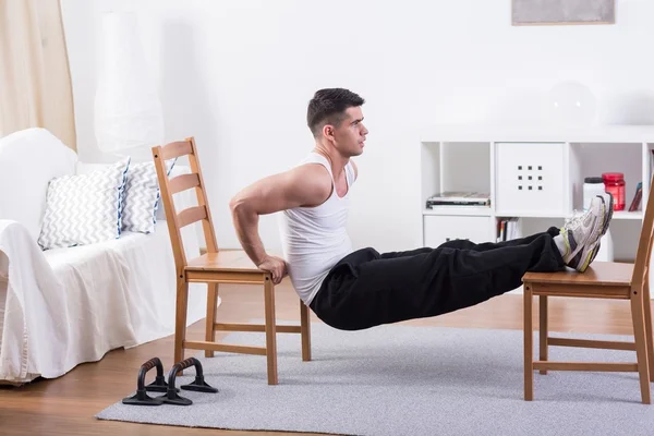 Fit man stretching at home — Stock Photo, Image