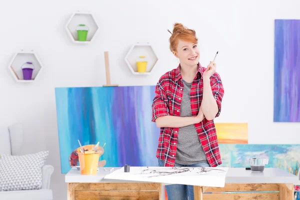 Artistic soul in the company of her paintings — Stock Photo, Image