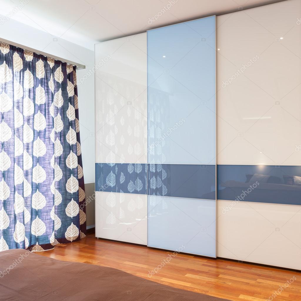 Blue and white wardrobe in bedroom Stock Photo by ©photographee.eu