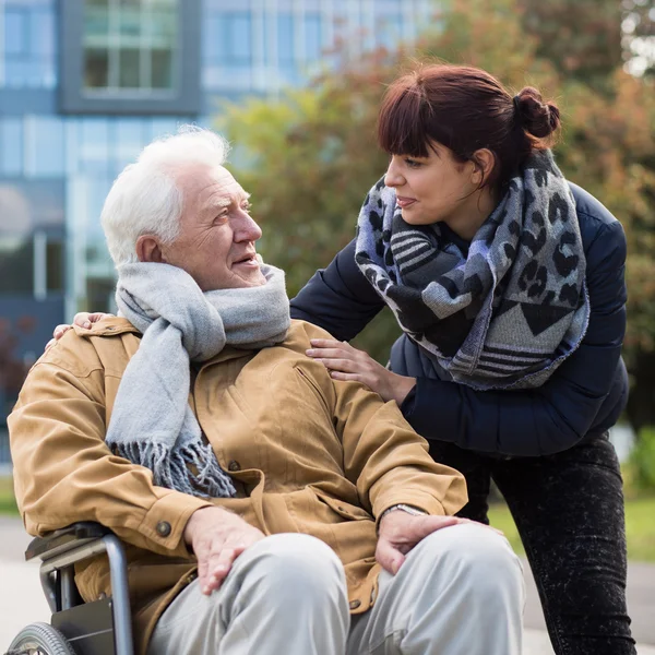 Granddaughter and disabled grandpa — Stock Photo, Image