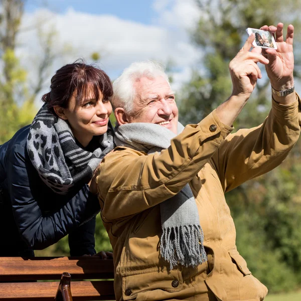 Elderly male taking photo — Stock Photo, Image