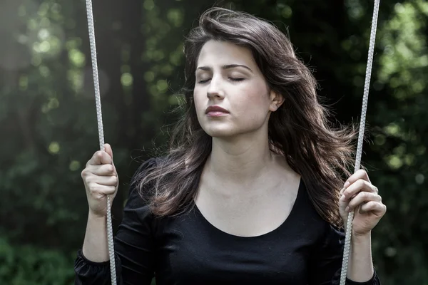 Woman swinging with closed eyes — Stock Photo, Image