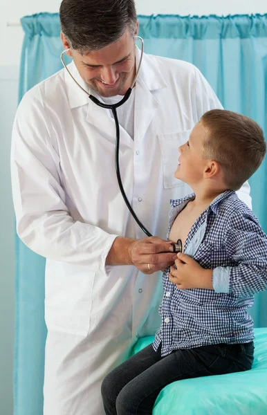 Pediatrician examining little boy Stock Picture