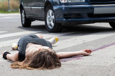 Dead woman lying on a street clipart