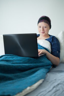 Young woman with tumor using internet clipart