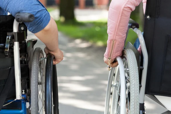 Couple of friends on a wheelchair — Stock Photo, Image