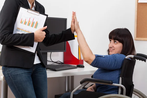 Woman on wheelchair and her co-worker — Stock Photo, Image