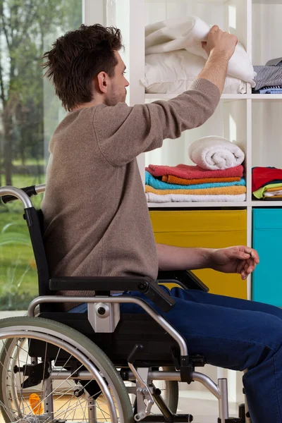 Disabled man reaching out for blanket — Stockfoto