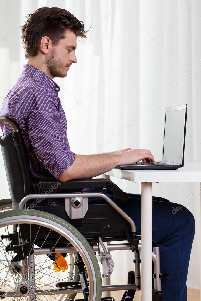 Disabled man surfing on the Internet