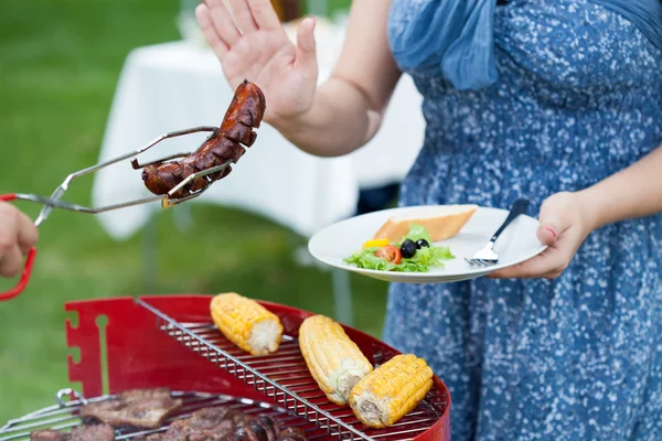 Woman on a diet during barbecue — Stock Photo, Image