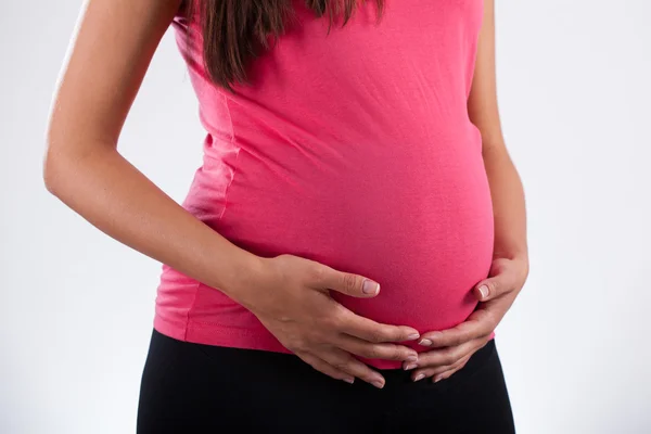 Mujer embarazada tocando su vientre —  Fotos de Stock