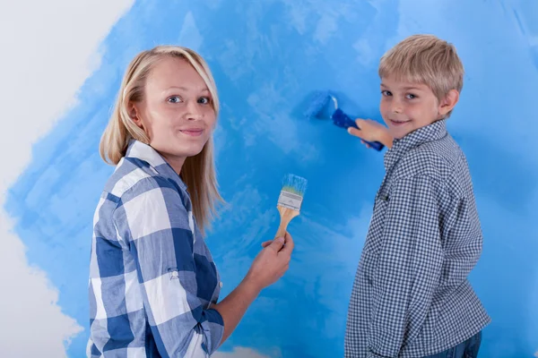 Sohn und junge Mutter beim Bemalen der neuen Wohnung — Stockfoto