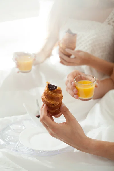 Close-up of eating in bed — Stock Photo, Image