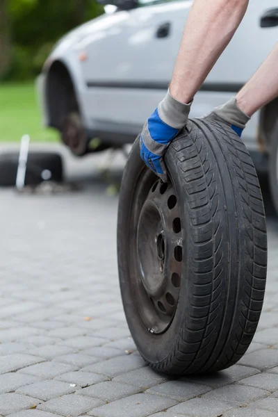 Rolling a spare of wheel — Stock Photo, Image