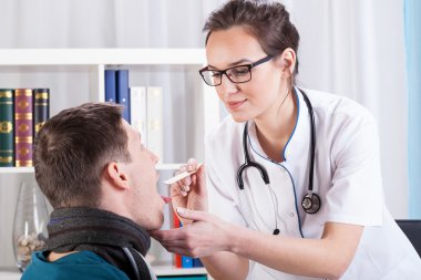 Doctor examining patient with sore throat clipart