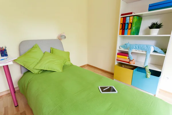 Digital tablet on bed in children bedroom — Stock Photo, Image