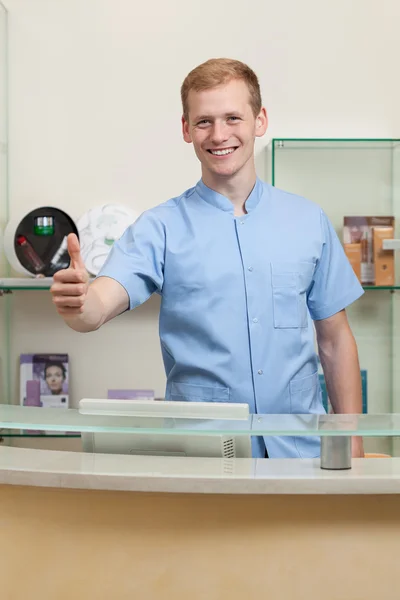 Male receptionist with okay gesture — Stock Photo, Image