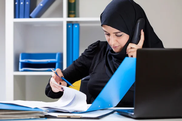 Muslim office worker looking for document — Stock Photo, Image