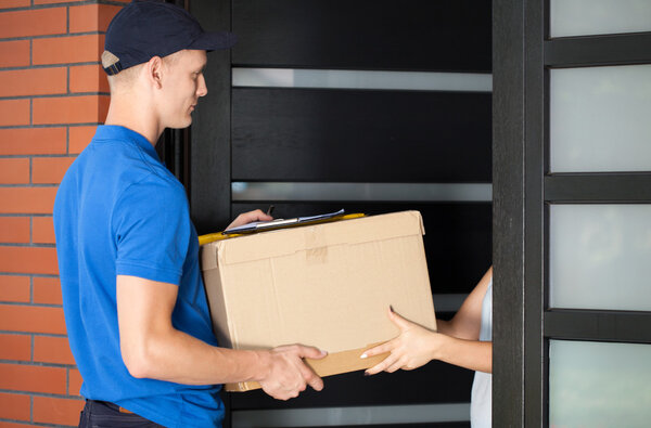 Delivery man handing in parcel