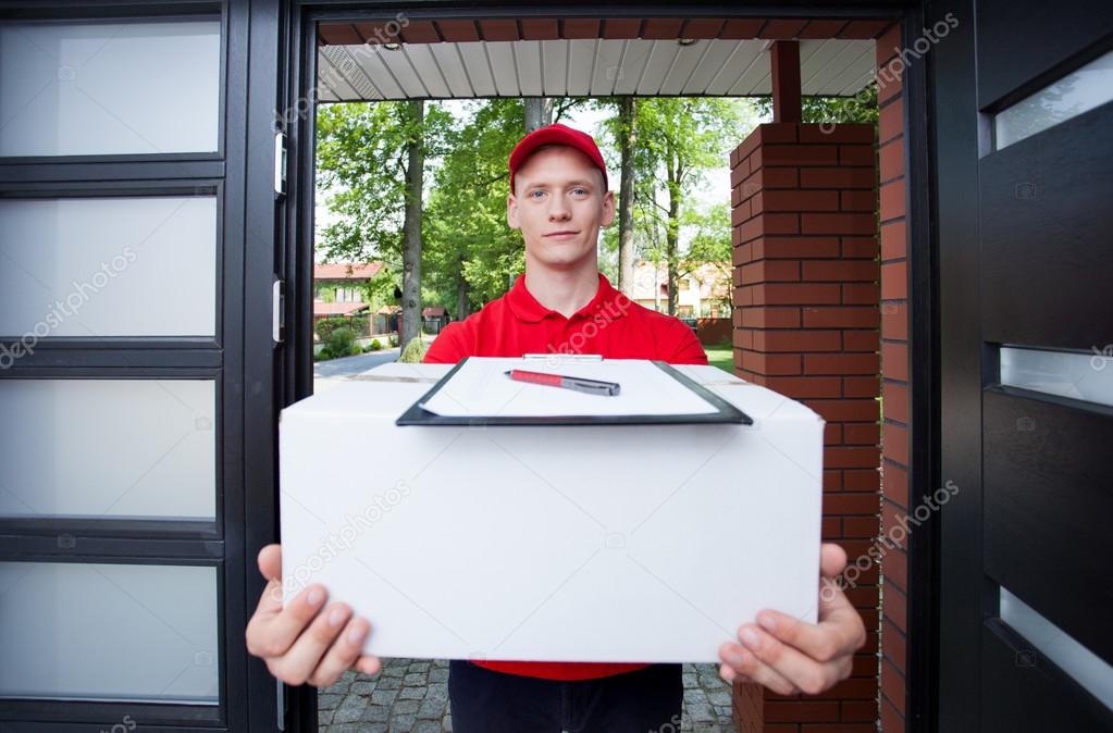 Delivery guy handing in parcel