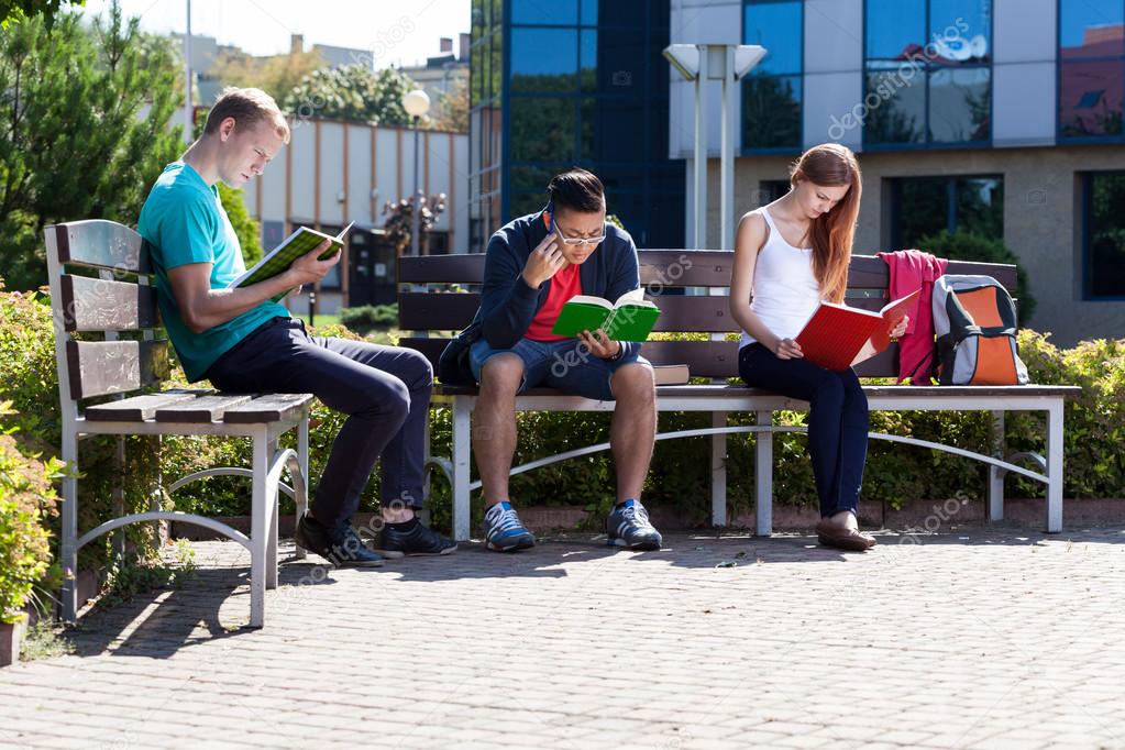 Students learning on a bench