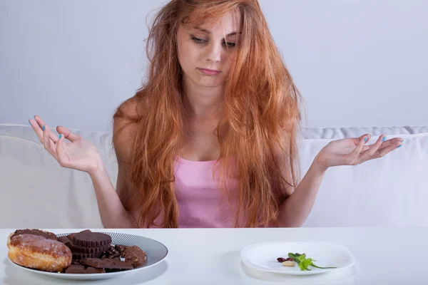 Girl trying to overcome hunger for sweets — Stock Photo, Image