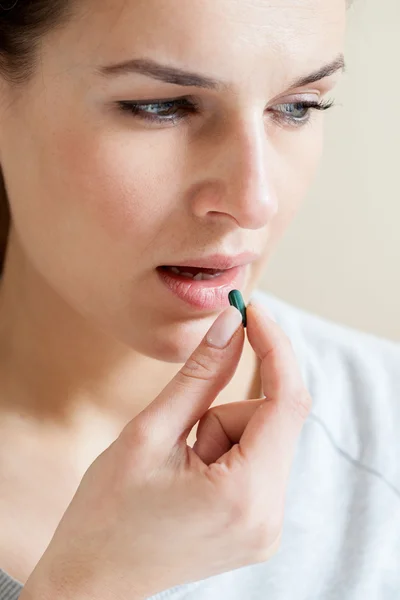 Ill woman taking a pill — Stock Photo, Image
