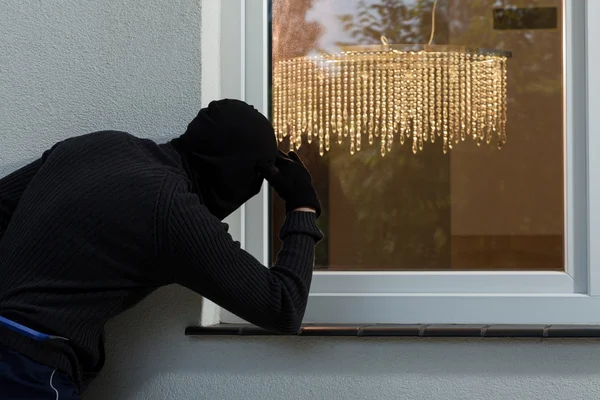 Burglar at a window — Stock Photo, Image