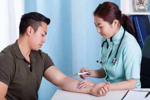 Male patient during injection — Stock Photo, Image