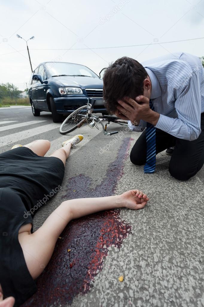 Bleeding woman on the pedestrian crossing