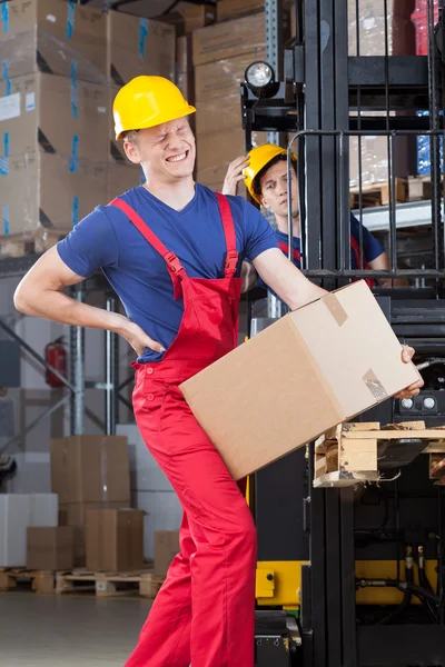 Man with a backache in factory — Stock Photo, Image