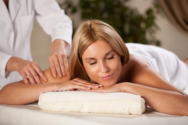 Woman relaxing during pleasant massage — Stock Photo, Image