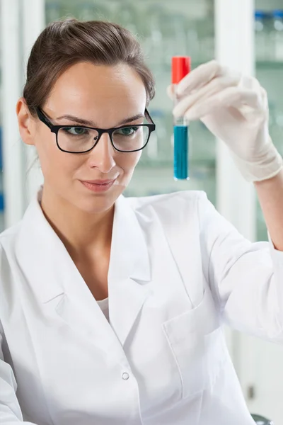 Chemist watching test tube — Stock Photo, Image