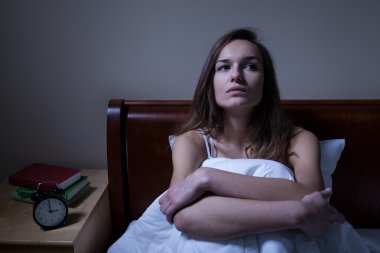Pensive woman stying sleepless at night clipart
