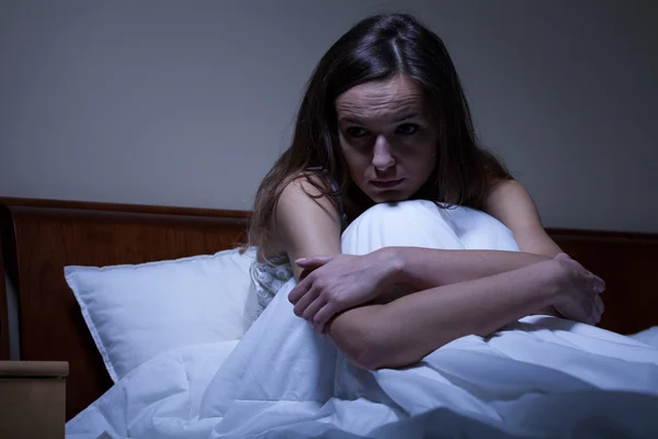 Worried woman in bed — Stock Photo, Image