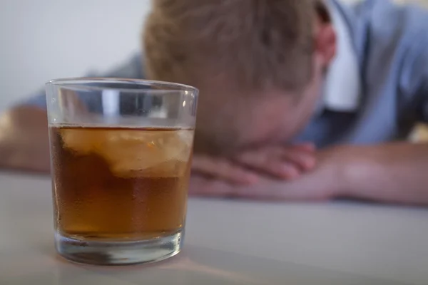 Sad man with a glass of whiskey — Stock Photo, Image