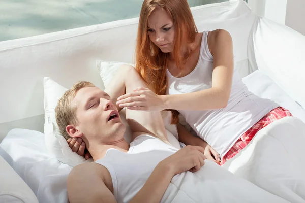 Woman irritated by snoring husband — Stock Photo, Image