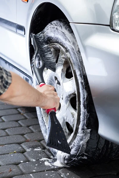 Hand cleaning car wheel — Stock Photo, Image