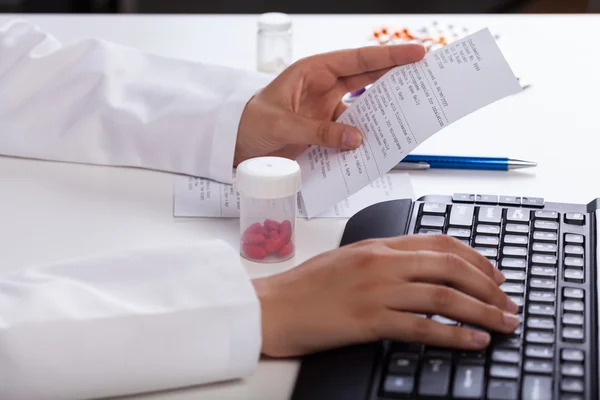 Pharmacist checking information about medicines — Stock Photo, Image