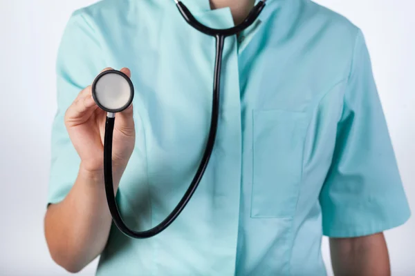 Doctor using stethoscope at work — Stock Photo, Image