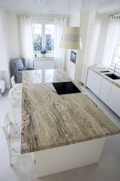 Big granitic worktop in bright kitchen — Stock Photo, Image