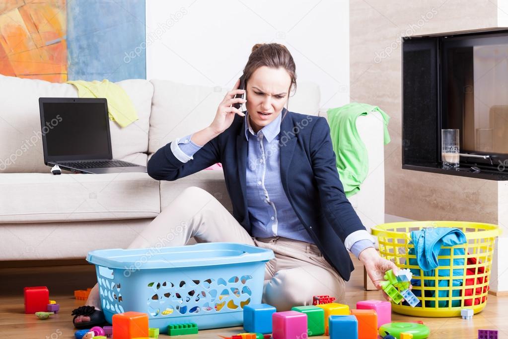 Mother organising toys and working