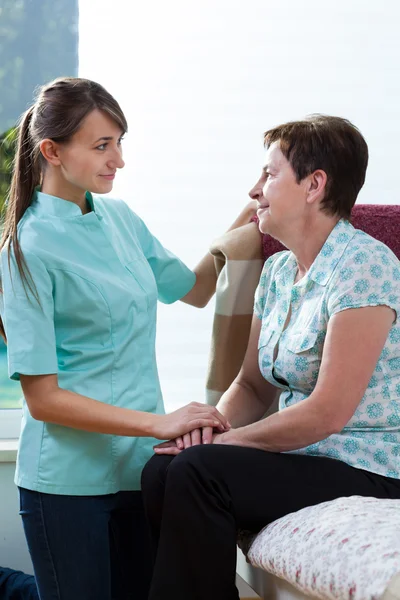 Young nurse caring about her patient — Stock Photo, Image