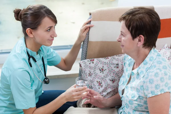 Nurse helping her patient — Stock Photo, Image