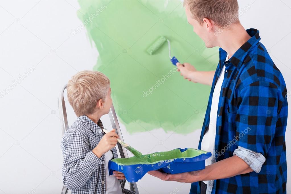 Dad and son painting wall